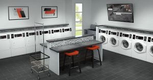 Laundry room with washers, dryers, folding table, two stools, laundry cart, wall art, and a TV screen.
