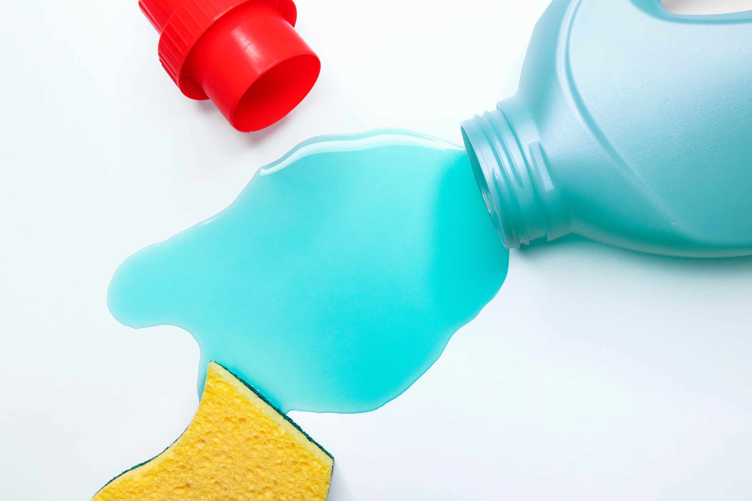 Good laundry room etiquette: spilled liquid laundry detergent with a sponge nearby for quick cleaning